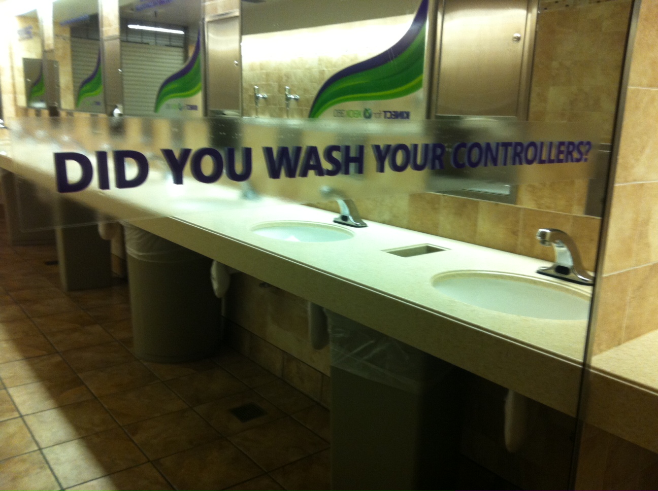 A photo of the hotel bathroom, where Microsoft had put up advertising stickers saying "Did you wash your controllers?"
